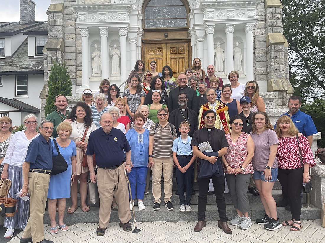 Msgr. Edward Arnister, center top, poses with a portion of the group of pilgrims from St. Rose Parish, Belmar, where he serves as pastor, and St. Teresa of Calcutta Parish, Bradley Beach, on the steps of the National Shrine of the Divine Mercy in Stockbridge, Mass. Courtesy photo