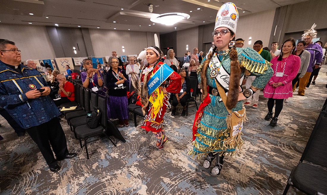 From left, Amber Tseabe Roy and Pheji Hota-Wiya G. Cosson perform a Native American dance July 20, 2023, during the grand march of the Tekakwitha Conference in Bloomington, Minn. They belong to St. Kateri Rosary Circle in Chicago. (OSV News photo/Dave Hrbacek, The Catholic Spirit)