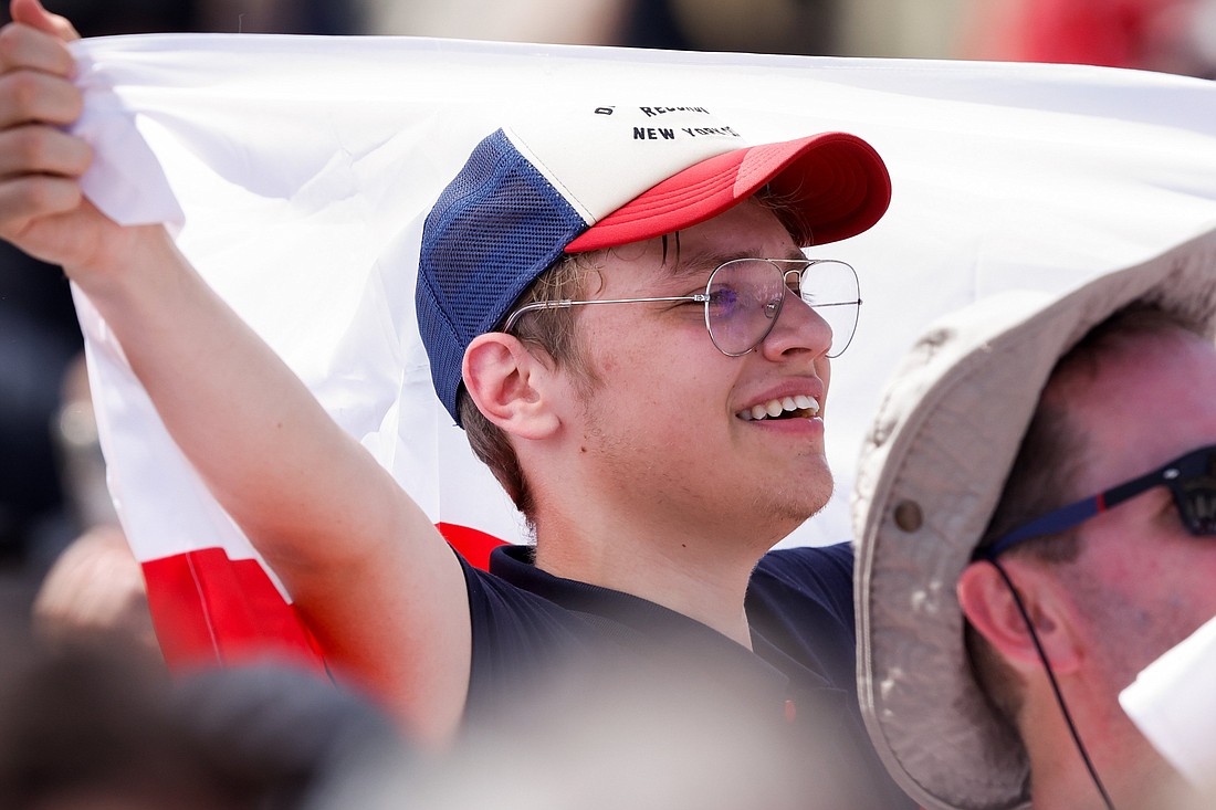 A young man smiles as Pope Francis prays the Angelus with visitors gathered in St. Peter's Square at the Vatican July 16, 2023. (CNS photo/Lola Gomez)