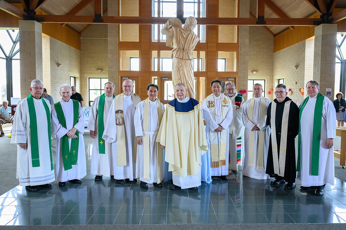 Father Robert Grodnicki, center, stands surrounded by fellow clergy members as they gathered to celebrate his retirement Mass in St. Luke Parish, Toms River. Mike Ehrmann photos