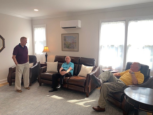Father Andrew Jamieson, left, Msgr. Sean Flynn, seated center, and Bishop O'Connell enjoy conversation during the Bishop's July 27 visit to Villa St. Denis, the newest diocesan facility for retired priests. Courtesy photos