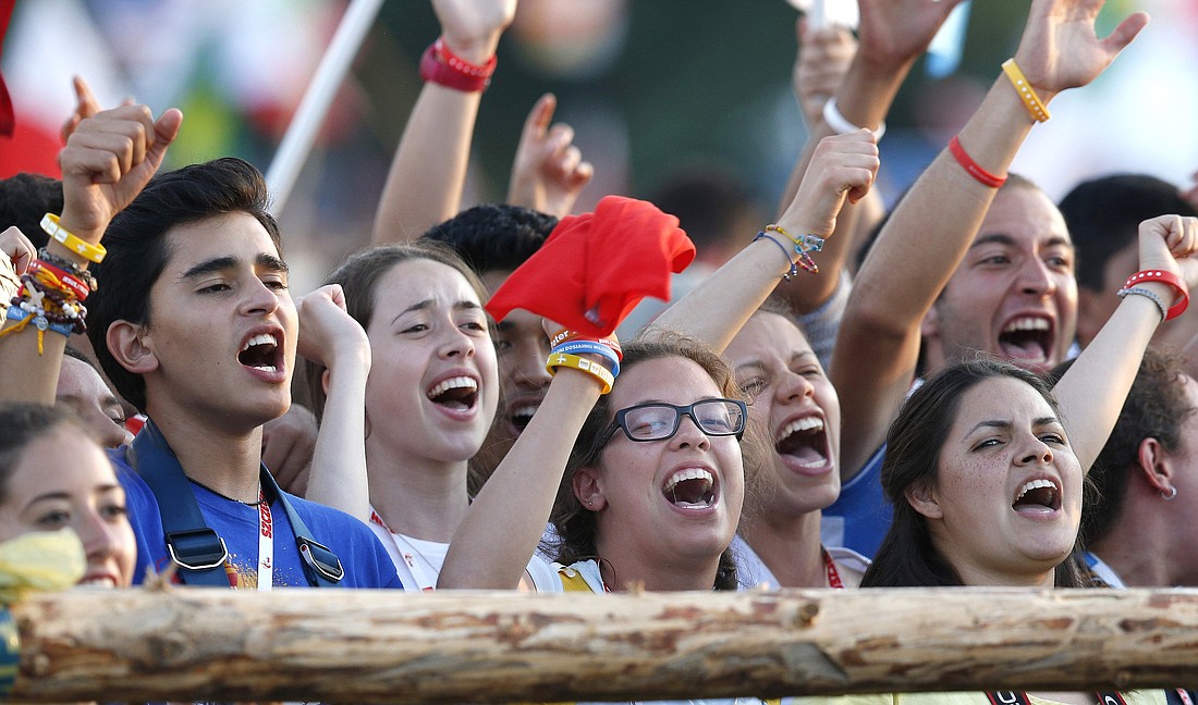 Pilgrims cheer after the Way of the Cross during World Youth Day in 2016 at Blonia Park in Krakow, Poland. (CNS photo/Paul Haring)