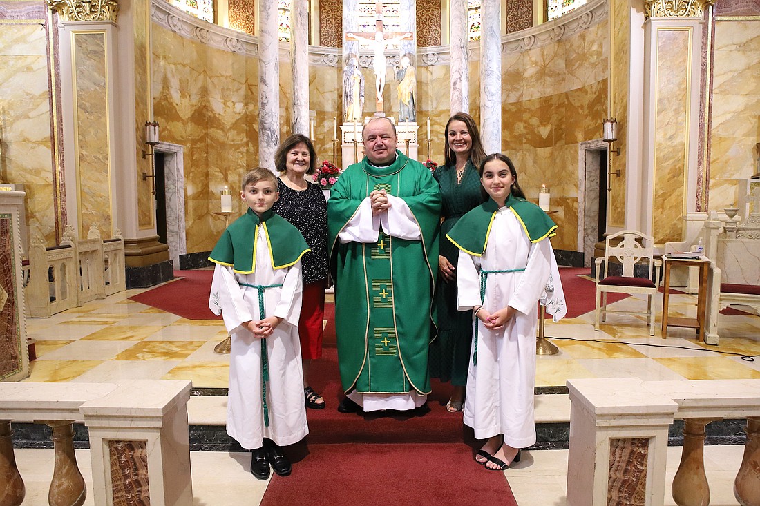 Father Kokorzycki poses for a photo with parishioners of Sacred Heart Parish, Trenton, where he celebrates Mass for members of the Polish community. John Batkowski photo