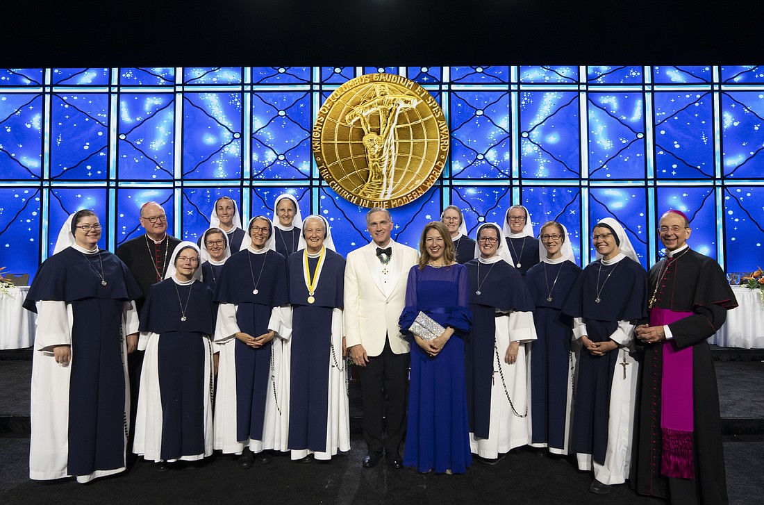 Supreme Knight Patrick Kelly and wife Vanessa (center), New York Cardinal Timothy M. Dolan (second from left) and Knights Supreme Chaplain Archbishop William E Lori of Baltimore (right) gather Aug. 1, 2023, with Mother Agnes Mary Donovan and other members of the Sisters of Life after the annual States Dinner of the Knights of Columbus 141st Supreme Convention in Orlando, Fla. During the dinner, Mother Agnes received the Gaudium et Spes Award -- the Knights' highest honor -- for her leadership of the Sisters of Life as founding superior over the past 30 years. (OSV News photo/Matt Barrick, via Knights of Columbus)
