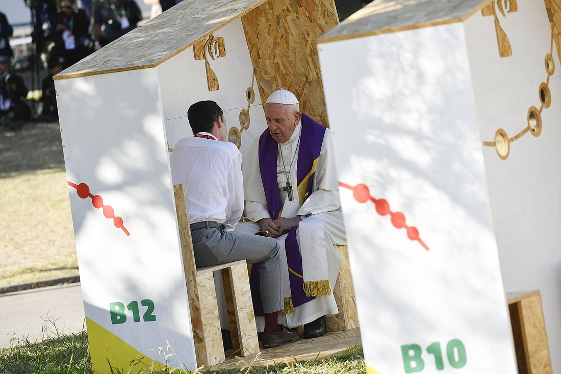 Pope Francis hears the confession of a World Youth Day pilgrim in Vasco da Gama Garden in Lisbon, Portugal, Aug. 4, 2023. The pope administered the sacrament to three pilgrims: young men from Italy and Spain, and a young woman from Guatemala. (CNS photo/Vatican Media)