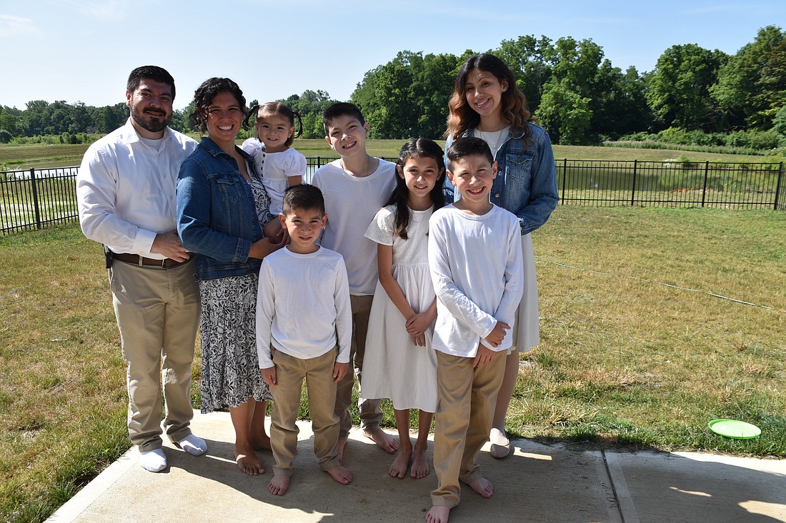 The Cabrera family poses outside of their home in Camby. They are, from left, Daniel, Maria, Fatima Lucia, Joseph, Daniel, Gianna, David and Sarah. (OSV News photo/Natalie Hoefer, The Criterion)