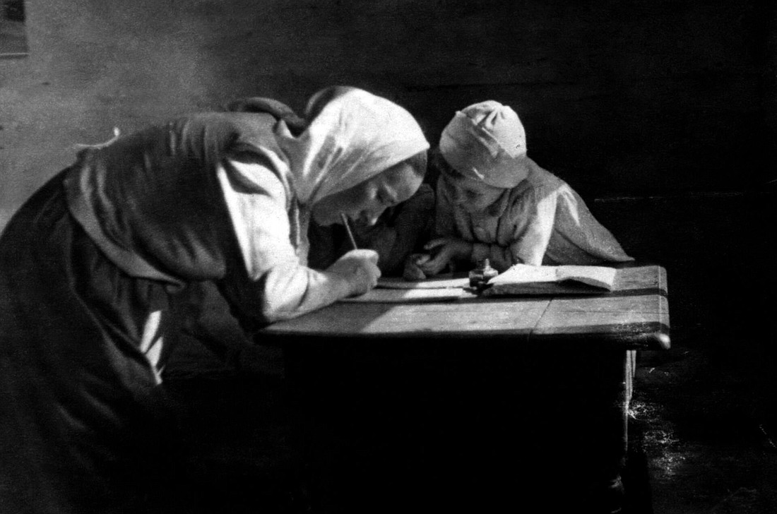 Wiktoria Ulma is pictured writing at a table with her oldest daughter, Stasia. The Ulma family secretly hid eight Jews for almost two years in German-occupied Poland during the Second World War. The Nazis killed the family and the Jews they were sheltering early in the morning March 24, 1944. The Vatican declared the Ulma family martyrs Dec. 17, 2022, and they will be beatified Sept. 10, 2023. (OSV News photo/courtesy Polish Institute of National Remembrance)
