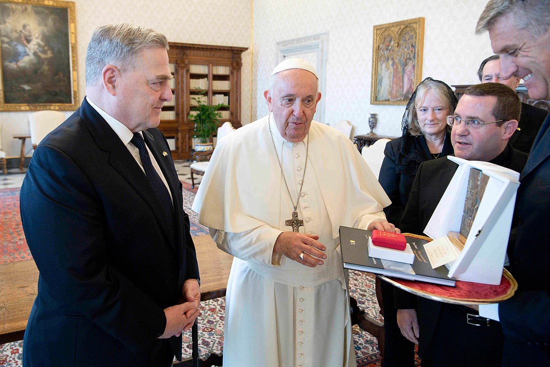 Pope Francis gives U.S. Gen. Mark A. Milley, chairman of the Joint Chiefs of Staff, a sculpture that says, "Peace is a fragile flower," during a meeting at the Vatican Aug. 21, 2023. (CNS photo/Vatican Media)