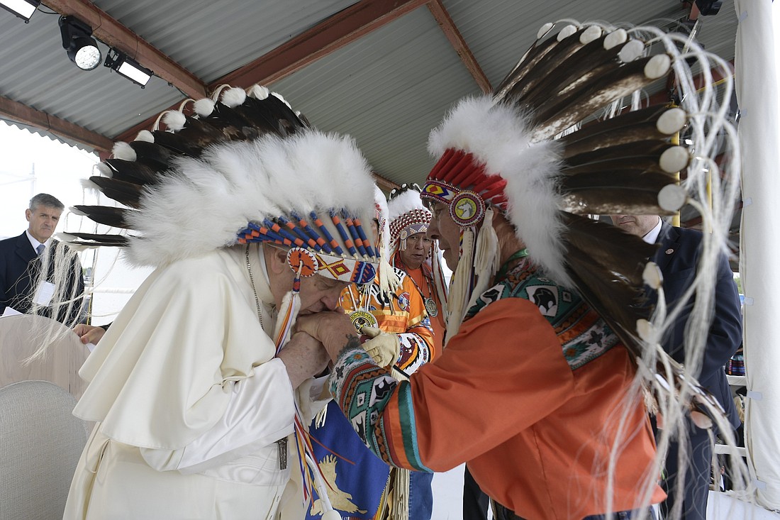 Pope Francis kisses the hand of an Indigenous leader during a meeting with First Nations, Métis and Inuit communities at Maskwacis, Alberta, July 25, 2022. (CNS photo/Vatican Media)