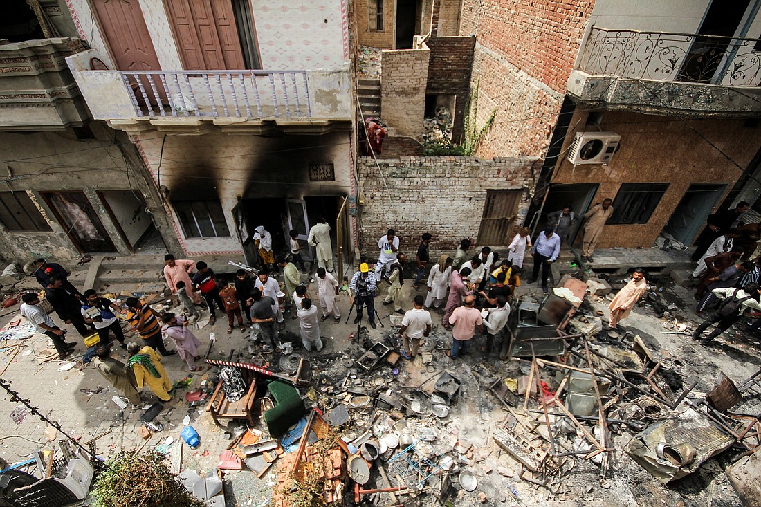 Residents gather along a street in the Christian neighborhood of Jaranwala, Pakistan, Aug. 17, 2023, a day after church buildings and houses were vandalized by protesters. (OSV News photo/Muhammad Tahir, Reuters)