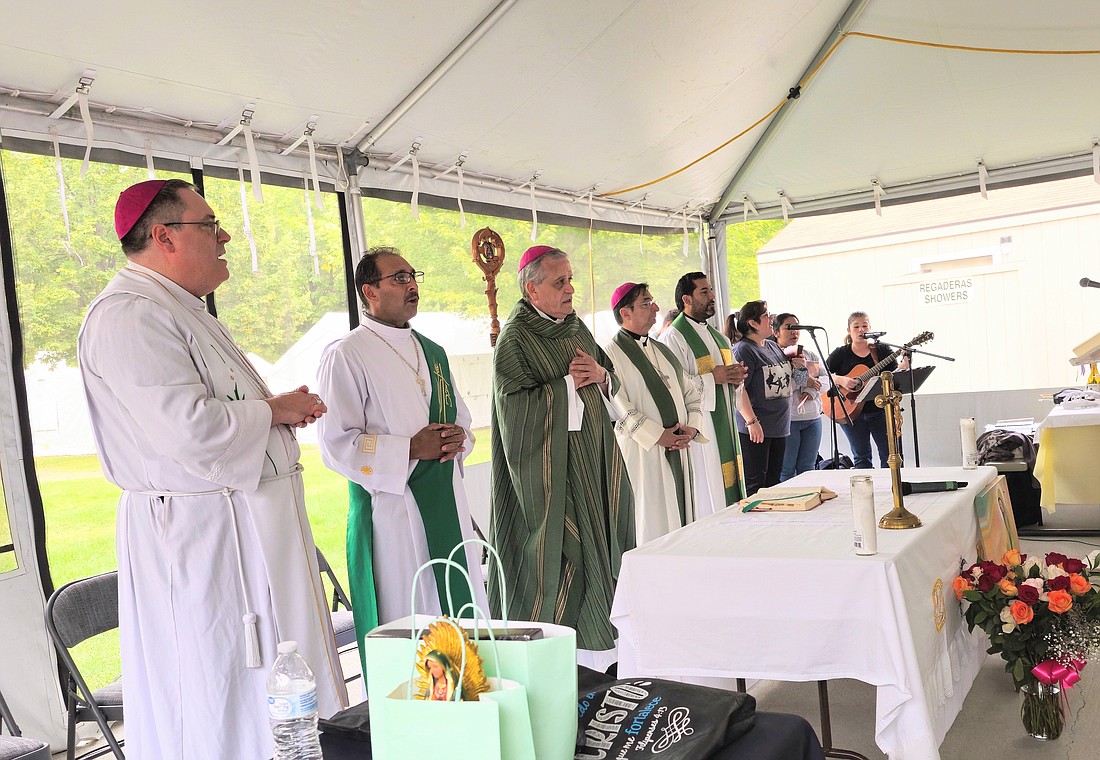 Bishops from the Pacific Northwest celebrate Mass with farmworkers at a migrant camp in Monitor, near Wenatchee, Wash., at the end of a U.S. bishops' pastoral visit to the Diocese of Yakima, Aug. 29, 2023. The bishops are, from left: Seattle Auxiliary Bishop Frank R. Schuster, Yakima Bishop Joseph J. Tyson and Auxiliary Bishop Eusebio L. Elizondo. (OSV News photo/courtesy of Ana Contreras and USCCB)