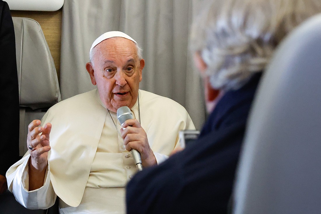 Pope Francis answers a question from a journalist aboard his flight back to Rome from Ulaanbaatar, Mongolia, Sept. 4, 2023, after a four-day visit to the Asian country. (CNS photo/Lola Gomez)