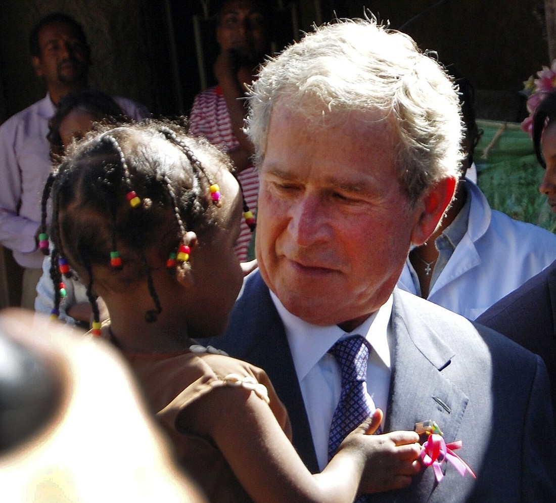 Former U.S. President George W. Bush carries an Ethiopian child whose mother is receiving HIV treatment through programs funded by the President's Emergency Plan for AIDS Relief, or PEPFAR, after arriving in the capital Addis Ababa Dec. 4, 2011. (OSV News photo/Aron Maasho, Reuters)