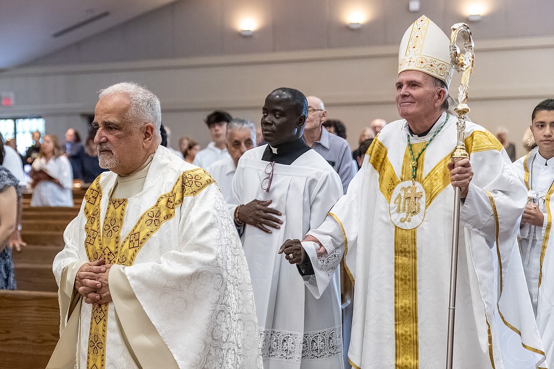 Msgr. Sam Sirianni, the Co-Cathedral's rector, and Bishop O'Connell process into church at the start of Mass. Hal Brown photo
