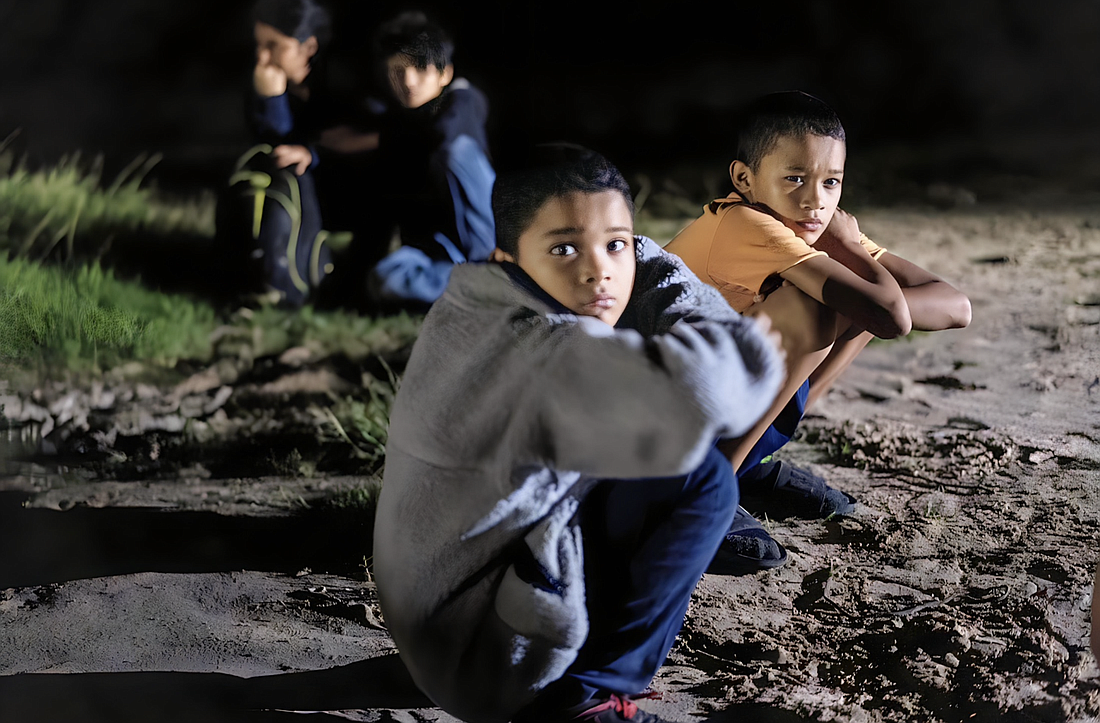 Unaccompanied minors who are migrants from Honduras sit on the riverbank in Roma, Texas, after crossing the Rio Grande July 9, 2021. OSV News photo/Go Nakamura, Reuters (Go Nakamura)
