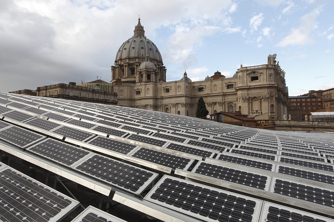Solar panels are seen on the roof of the Paul VI audience hall at the Vatican in this Dec. 1, 2010, file photo. The assembly of the Synod of Bishops Oct. 4-29 will be held in the audience hall and the synod office is committed to offsetting the gathering's carbon footprint. (CNS photo/Paul Haring)