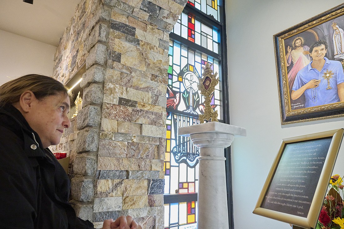 Antonia Salzano prays in the shrine dedicated to her son, Blessed Carlo Acutis. The shrine was dedicated by Bishop O'Connell on Oct. 1. Mike Ehrmann photo