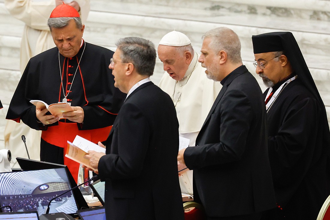 Pope Francis prays with participants in the assembly of the Synod of Bishops in the Vatican's Paul VI Audience Hall during the first working session of the assembly Oct. 4, 2023. (CNS photo/Lola Gomez)