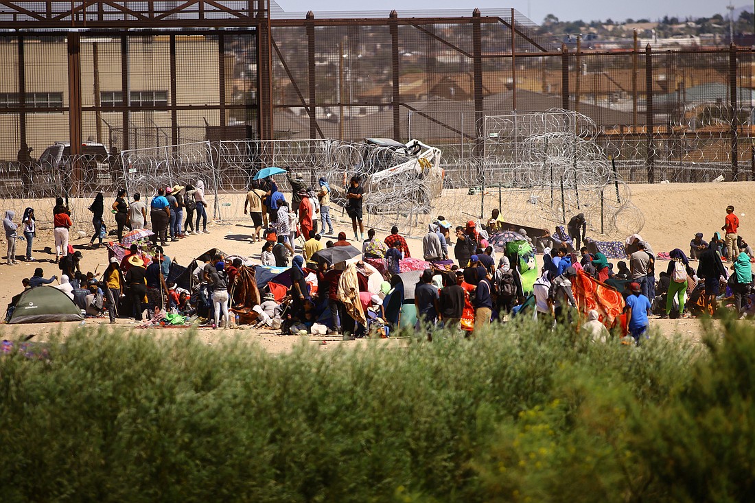 Migrants, mostly from Venezuela, are seen from Ciudad Juarez, Mexico, as they gather near the U.S. border wall Sept. 24, 2023, after crossing the Rio Grande with the intention of turning themselves in to U.S. Border Patrol agents to request asylum. (OSV News photo/Jose Luis Gonzalez, Reuters)