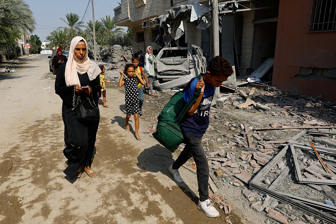 People flee their homes amid Israeli strikes in the southern Gaza Strip, October 8, 2023. (OSV News/Ibraheem Abu Mustafa, Reuters)