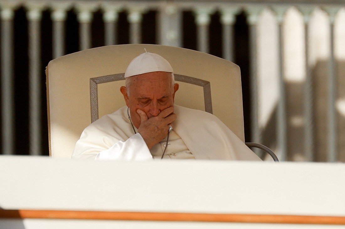 Pope Francis places his hand on his face during his weekly general audience in St. Peter's Square at the Vatican Oct. 11, 2023. (CNS photo/Lola Gomez)