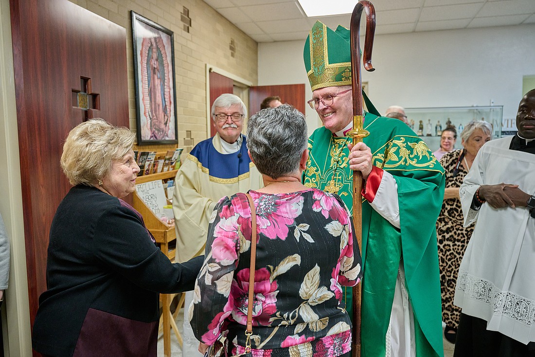 Bishop O'Connell greets parishioners from Visitation Church, Brick, following the Mass he celebrated marking the parish's 75th anniversary. Standing next to the Bishop is Father Edward Blanchett, current Visitation pastor. Mike Ehrmann photo