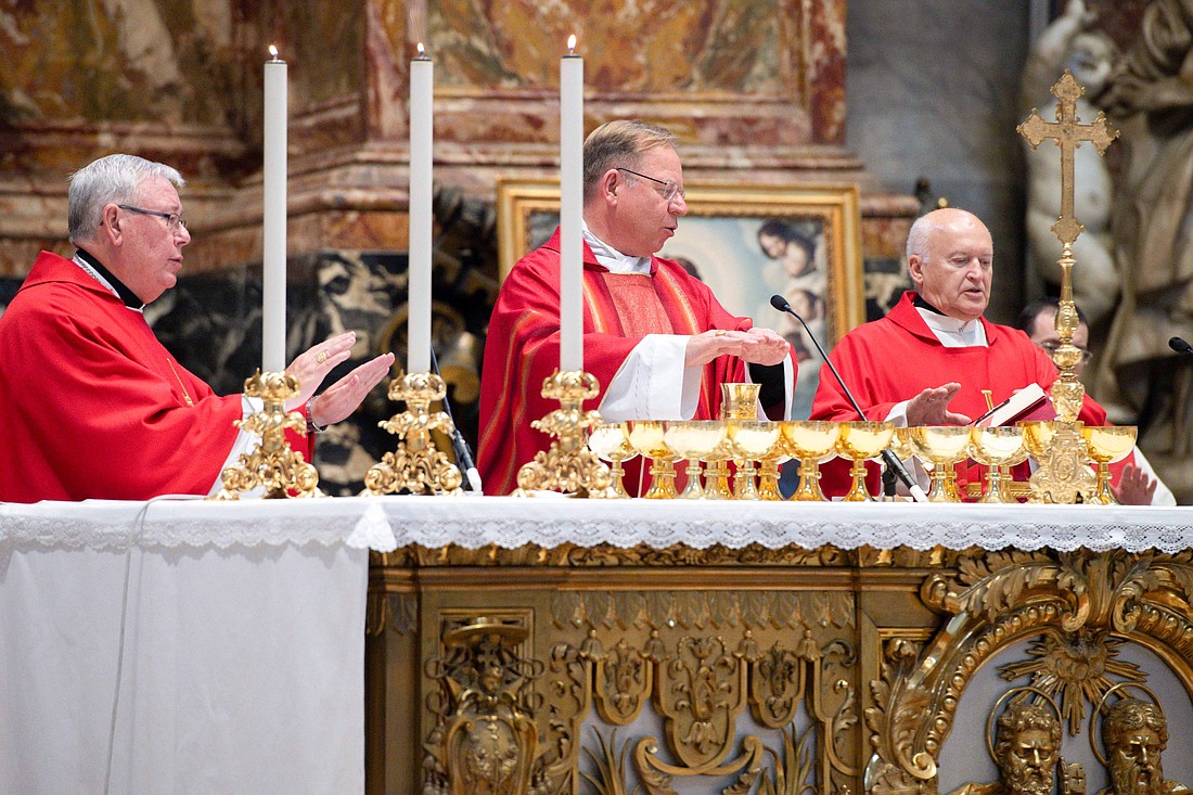 Lithuanian Archbishop Gintaras Grušas of Vilnius celebrates Mass to open the fourth and final module of the assembly of the Synod of Bishops at the Altar of the Chair in St. Peter's Basilica at the Vatican Oct. 18, 2023. Concelebrating to the left is Cardinal Jean-Claude Hollerich, relator general of the synod assembly, and to the right is Serbian Archbishop Ladislav Nemet of Belgrade. (CNS photo/Vatican Media)