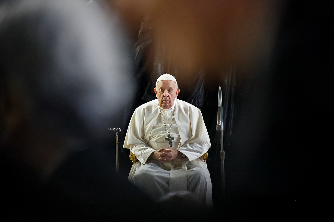 Pope Francis waits for members of the assembly of the Synod of Bishops before a prayer service for migrants and refugees in St. Peter's Square at the Vatican Oct. 19, 2023. (CNS photo/Lola Gomez)