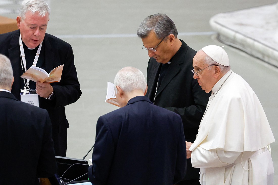 Pope Francis joins leaders of the assembly of the Synod of Bishops for prayer before a working session in the Vatican's Paul VI Audience Hall Oct. 17, 2023. (CNS photo/Lola Gomez)