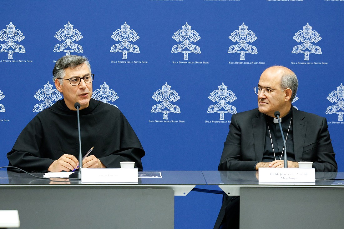 Franciscan Father Enzo Fortunato speaks at a Vatican news conference Oct. 17, 2023, about a Nov. 6 event thousands of children will attend to meet with Pope Francis at the Vatican. Cardinal José Tolentino Mendonça, prefect of the Dicastery for Culture and Education, which is sponsoring the event, listens. (CNS photo/Lola Gomez)