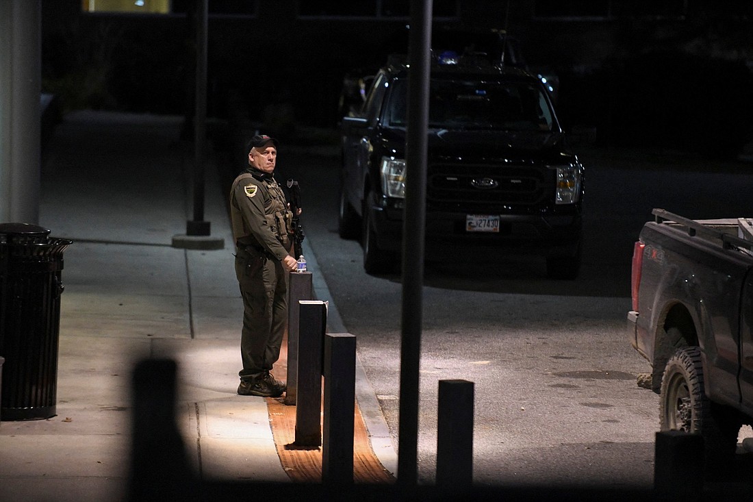 A police officer is stationed outside the Central Maine Medical Center in Lewiston, Maine, Oct. 26, 2023, after deadly mass shootings the evening before. A man shot and killed at least 18 people and injured 13 others at a restaurant and a bowling alley in Lewiston Oct. 25, and then fled into the night, sparking a massive search by hundreds of officers while frightened residents stayed locked in their homes. (OSV News photo/Nicholas Pfosi, Reuters)