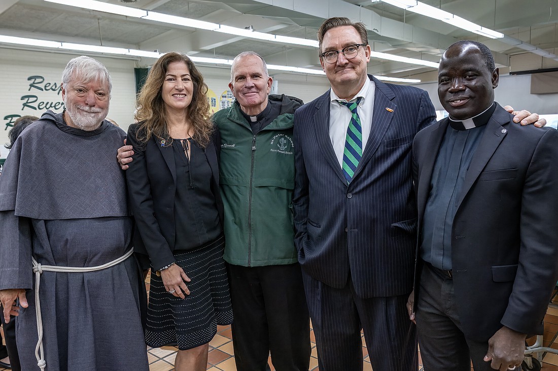 During the 100th anniversary celebration of St. Peter School, Point Pleasant Beach, Bishop O'Connell poses for a photo with Conventual Franciscan Father Robert Schlageter, pastor of St. Peter Parish; Tracey Kobrin, school principal; Dr. Vincent de Paul Schmidt, diocesan superintendent of Catholic schools, and Father Jean Felicien, the Bishop's secretary and master of ceremonies. Hal Brown photo