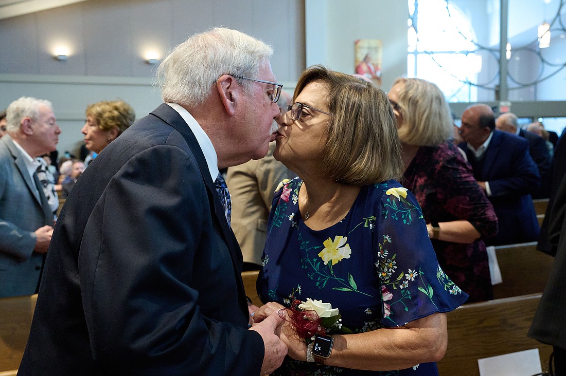 Donna and Dan Mahoney of St. Thomas More Parish, Manalapan, share a kiss during the Oct. 8 Mass in St. Robert Bellarmine Co-Cathedral, Freehold. Mike Ehrmann photo