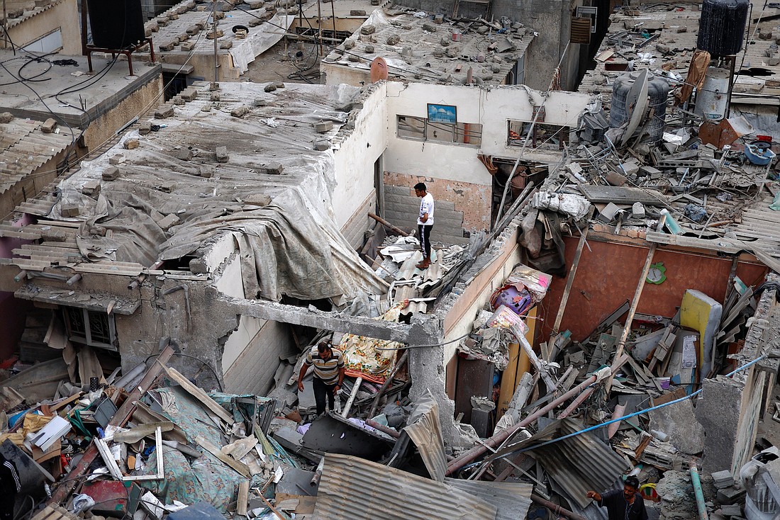 Palestinians check destroyed homes in Khan Younis in the southern Gaza Strip Oct. 29, 2023, following Israeli airstrikes amid the ongoing conflict between Israel and Palestinian Islamist group Hamas. (OSV News photo/Mohammed Salem, Reuters)