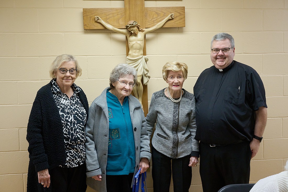 Father Santangelo, right, is shown with longtime parishioners following the Mass he celebrated for the opening of the parish's golden jubilee. Mike Ehrmann photo