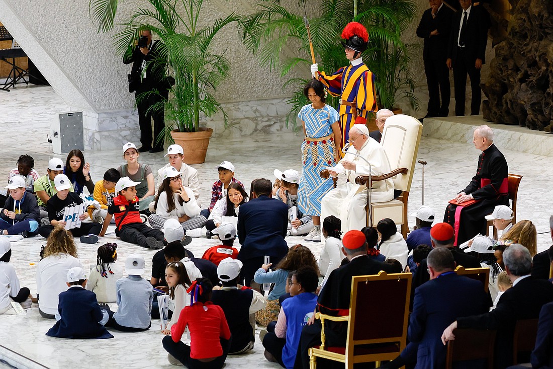 Pope Francis speaks to children from different parts of the world at the "Let Us Learn from Boys and Girls" event in the Paul VI hall at the Vatican Nov. 6, 2023. (CNS photo/Lola Gomez)