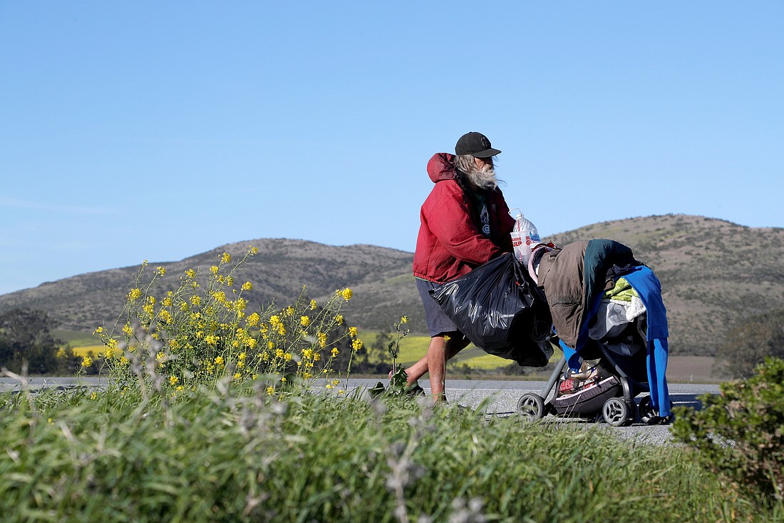 Eric, who says he is a homeless veteran of 20 years, walks with his belongings on State Route 1 outside of Davenport, Calif., March 2, 2020. On any given night, 40,056 U.S. veterans are homeless, according to the National Coalition for Homeless Veterans, citing U.S. Department of Housing and Urban Development estimates. HUD also reported that number of homeless veterans has decreased by about 50% since 2009.   (OSV News photo/Shannon Stapleton, Reuters)