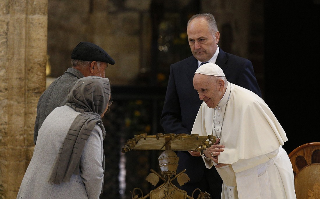 Pope Francis greets Afghan refugees Qadery Abdul Razaq and his wife, Salima, during a meeting with the poor at the Basilica of St. Mary of the Angels in Assisi, Italy, Nov. 12, 2021. The visit was in preparation for the celebration of the World Day of the Poor. (CNS photo/Paul Haring).