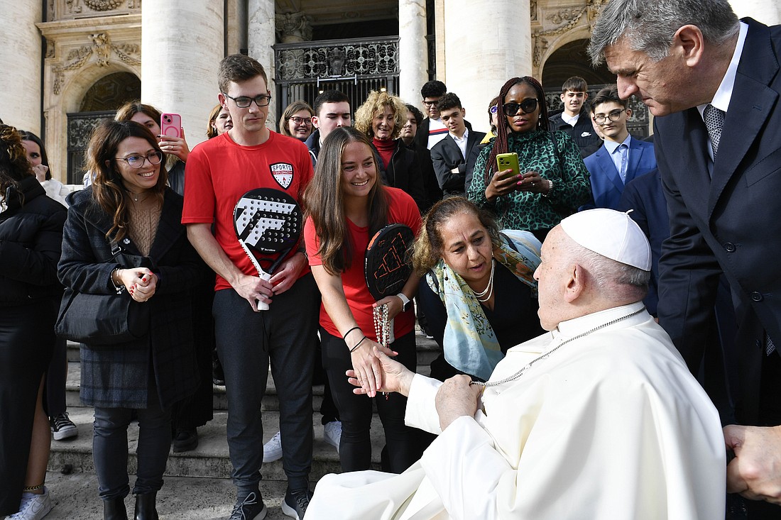 Pope Francis shakes hands with Andrea Samson as Anderson Good looks on after the pope's general audience in St. Peter's Square at the Vatican Nov. 15, 2023. Samson and Good, U.S. padel players who are part of the State Department's Sports Diplomacy program, were touring Italy at the invitation of the U.S. Embassy to the Holy See and Athletica Vaticana, the Vatican sports team. (CNS photo/Vatican Media)
