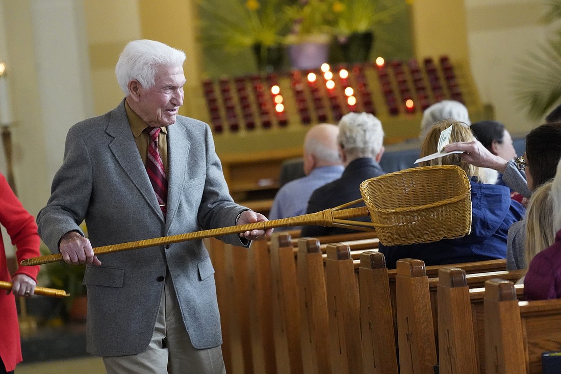 An usher uses a collection basket during the offertory portion of the Mass in this file photo from April 16, 2023. In many U.S. dioceses, a collection for the Catholic Campaign for Human Development, the U.S. bishops' domestic anti-poverty program,  will be taken at Masses the weekend of Nov. 18 and 19. The seventh annual World Day of the Poor Nov. 19 falls during the CCHD collection weekend. (OSV News photo/Gregory A. Shemitz)