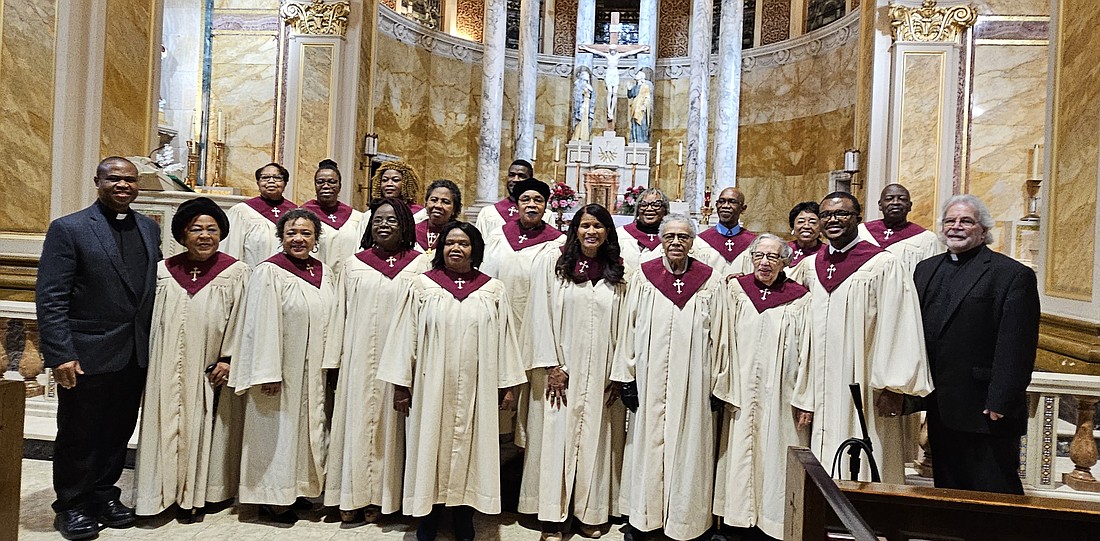 Father Charles Muorah, parochial vicar of Sacred Heart Parish, Trenton, far left, and Msgr. Dennis Apoldite, pastor, far right, pose for a photo with the parish's Gospel Choir during the "Give Thanks" concert held Nov. 19 in Holy Cross Church, Trenton. Mary Stadnyk photo