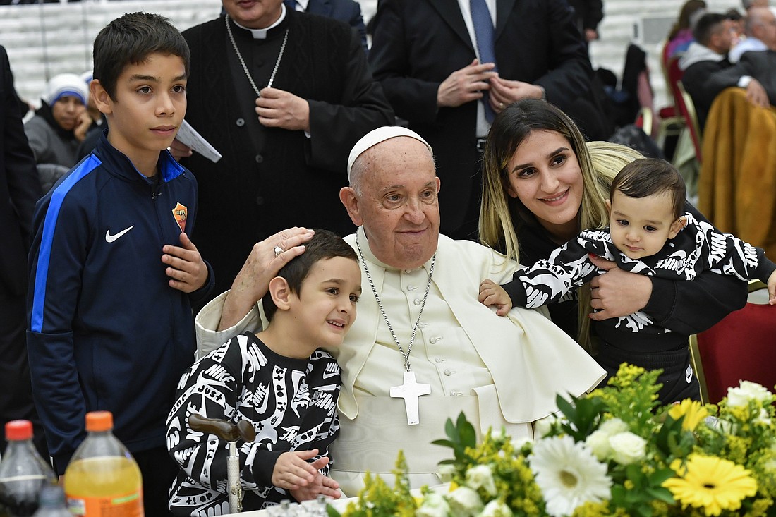 Pope Francis poses for a photo with his guests during a lunch in the Vatican audience hall Nov. 19, 2023, the World Day of the Poor. (CNS photo/Vatican Media)