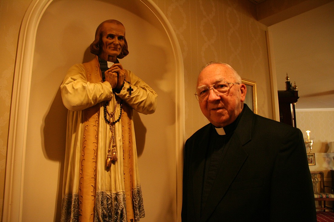 Father Radomski stands next to a statue of St. John Vianney the patron of parish priests located in Villa Vianney, the residence for retired priests of the Trenton Diocese in Lawrenceville. File photo