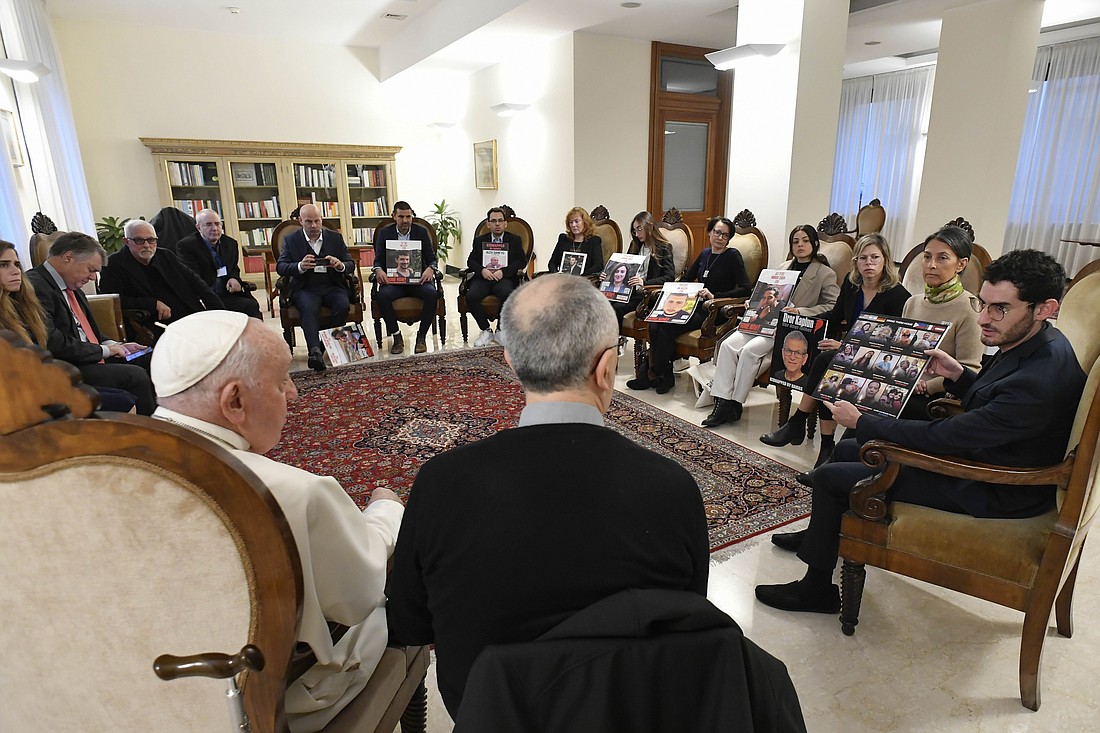 Pope Francis meets relatives of hostages taken by Hamas militants from Israel Oct. 7 in his residence, the Domus Sanctae Marthae, at the Vatican Nov. 22, 2023. Members of the delegation carried posters of their loved ones. (CNS photo/Vatican Media)