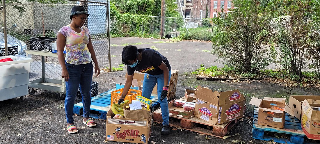 Volunteers help to box groceries during the Mount Carmel Guild's Summer Feeding Families program. File photo