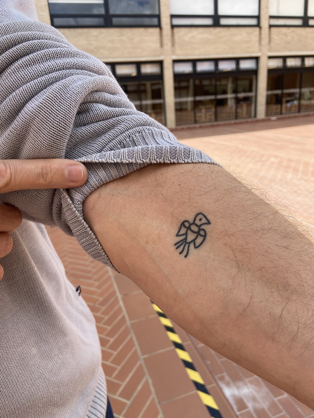 Jesuit Father Gustavo Morello, a professor of sociology of religion at Boston College, shows an arm tattoo during a theology conference in Bogotá, Colombia, Nov. 28, 2023. He told CNS the design is from 1600 and that he received it on pilgrimage to Loreto, Italy. (CNS photo/Justin McLellan)