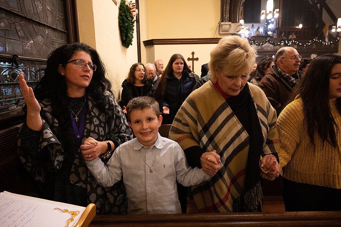 Parishioners of St. Rose Parish, Belmar, pray together during Mass during the Christmas season in this 2018 file photo. Mike Ehrmann photo