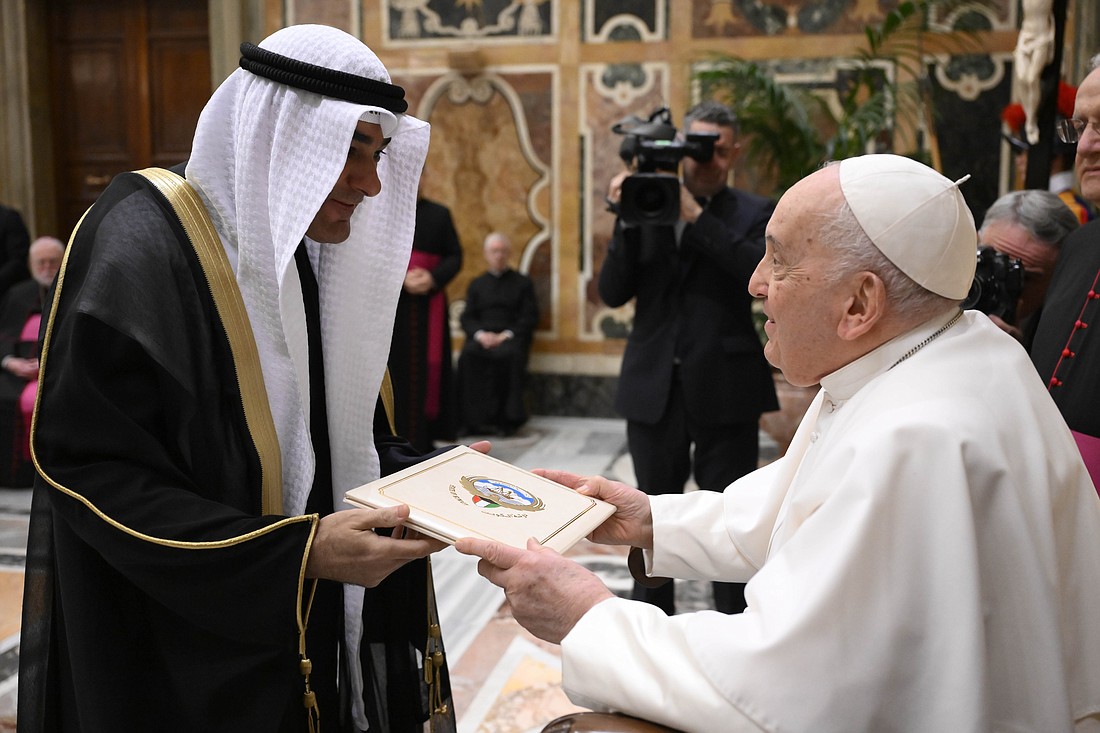 Yaqoub Youssef al-Sanad presents to Pope Francis his letters of credential as Kuwait's ambassador to the Holy See during an audience in the Apostolic Palace at the Vatican Dec. 7, 2023. (CNS photo/Vatican Media)