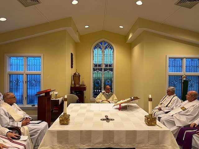 Among the priests shown in photo during the Mass with Bishop O'Connell are from left, Father Angelo Amaral, Father Stanley Lukaszewski and Msgr. Vincent Gartland. Staff photo