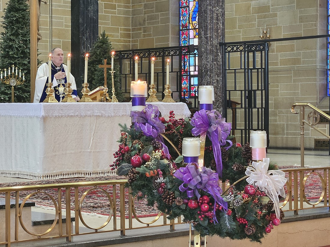 Bishop O'Connell stands at the altar during the Liturgy of the Eucharist at Mass. Mary Stadnyk photos